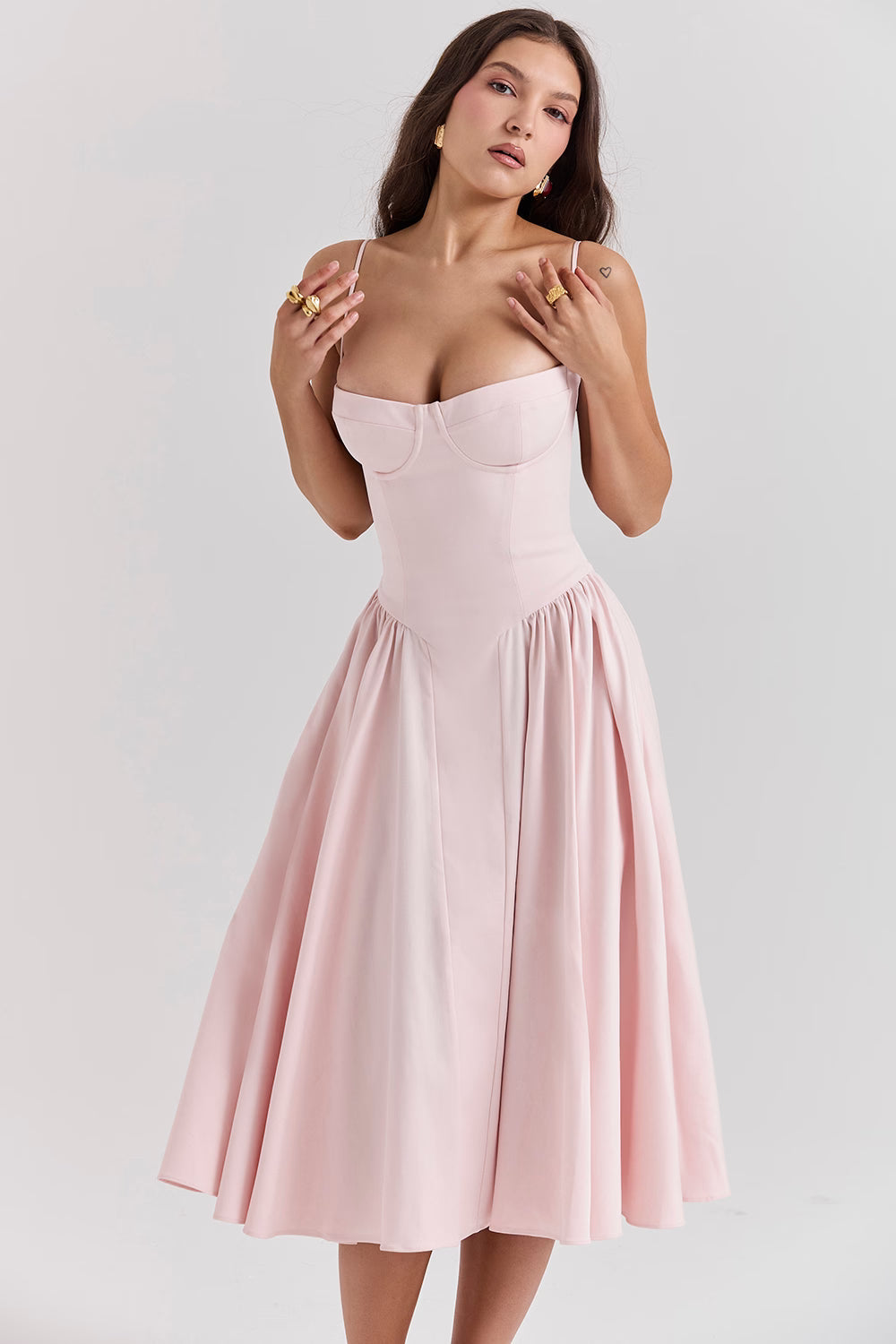 Woman wearing a pink dress against a plain background Blush elegant