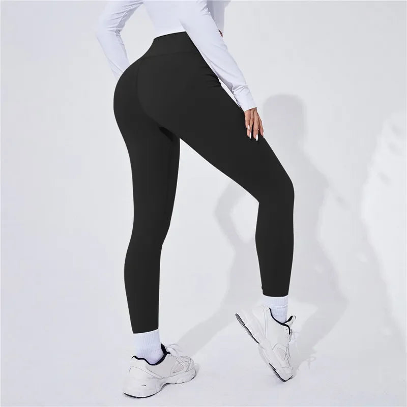 Person wearing Onyx leggings and white sneakers on a light gray background