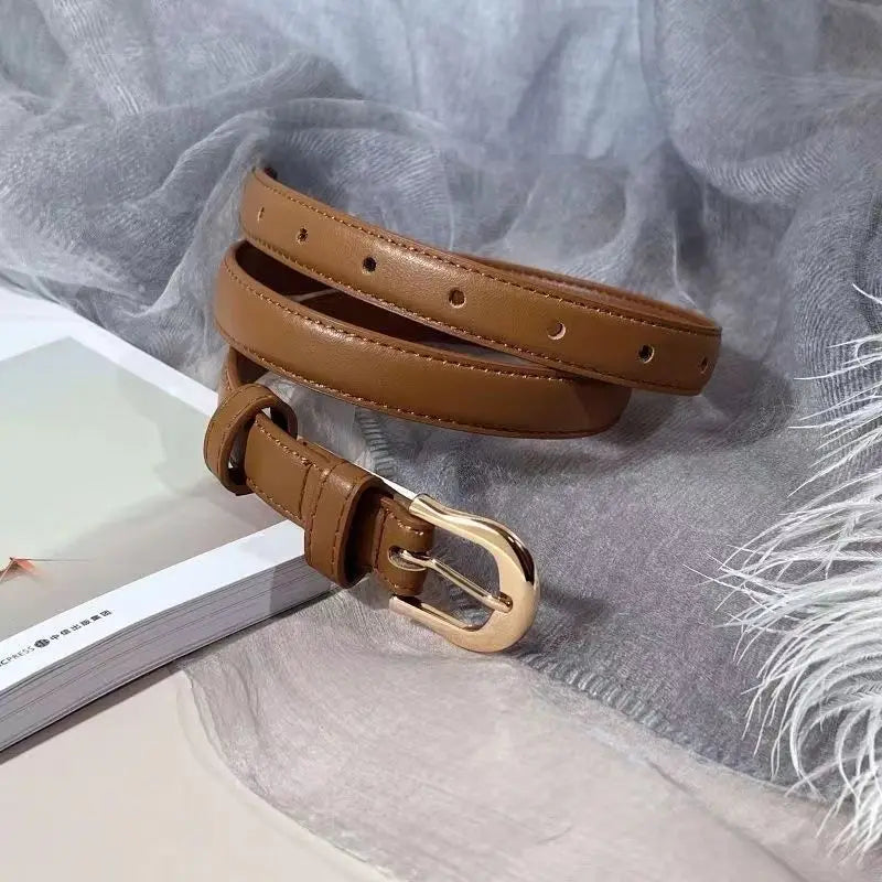 Brown Coffee leather belt with a gold buckle on a light gray fabric background