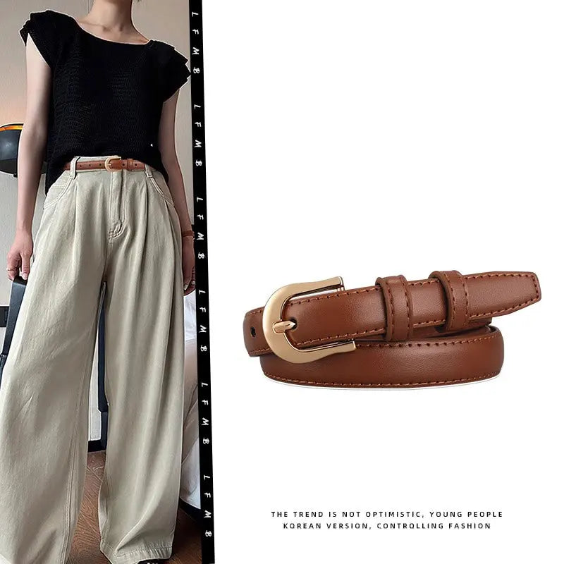 Coffee belt with gold buckle displayed with a person wearing a black top and beige pants.