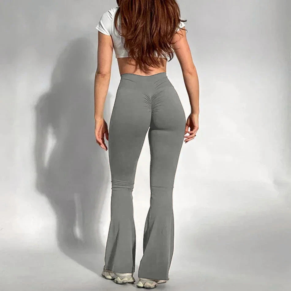 Person wearing Light Heather Grey flared pants and a white top on a plain background