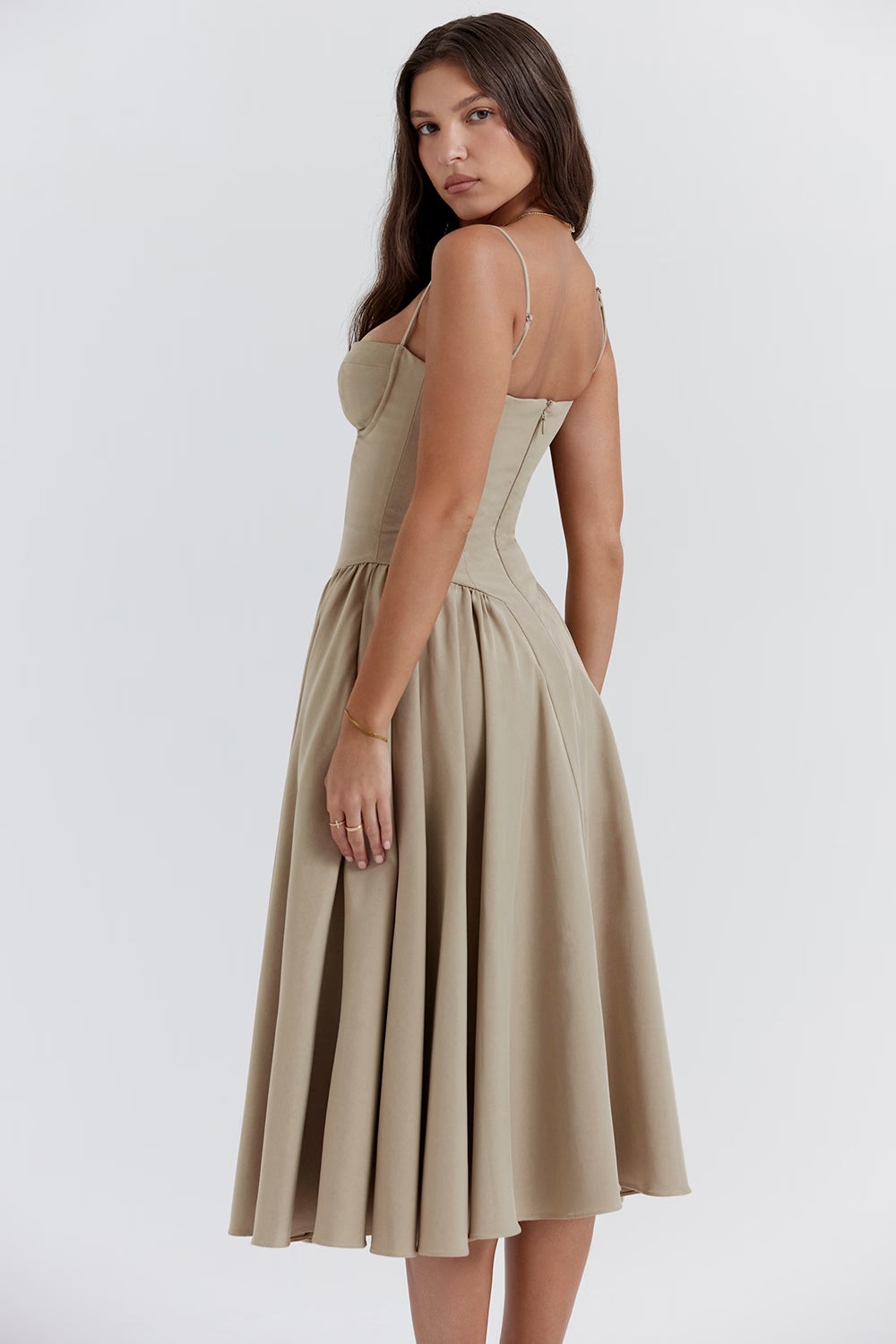 Woman wearing a beige Cherry Khaki dress on a white background